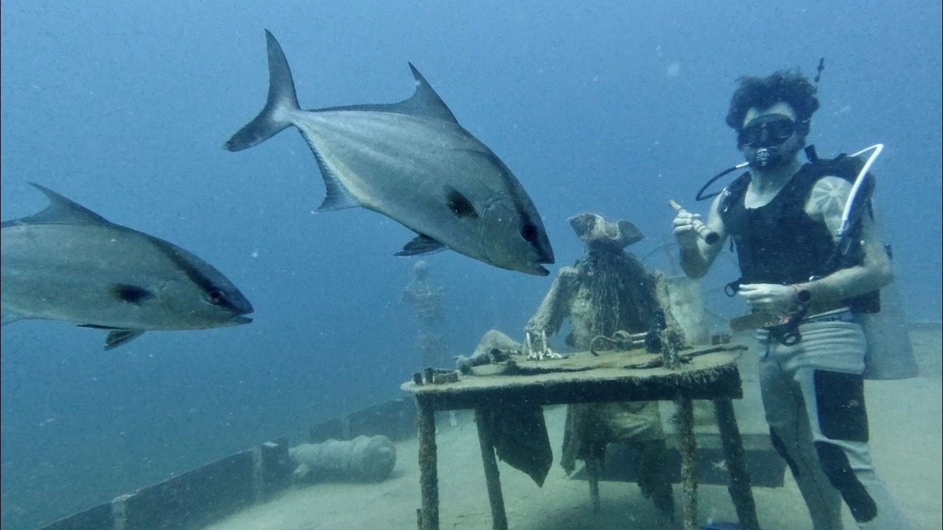 Fish gather around a sculpture on the BVI Art Reef