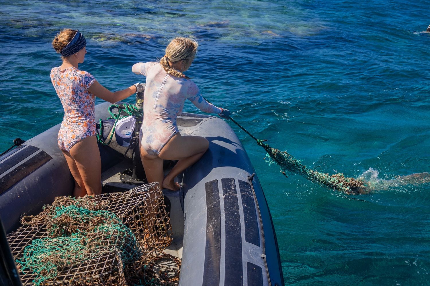 Beyond The Reef hauling ghost fishing net from the water