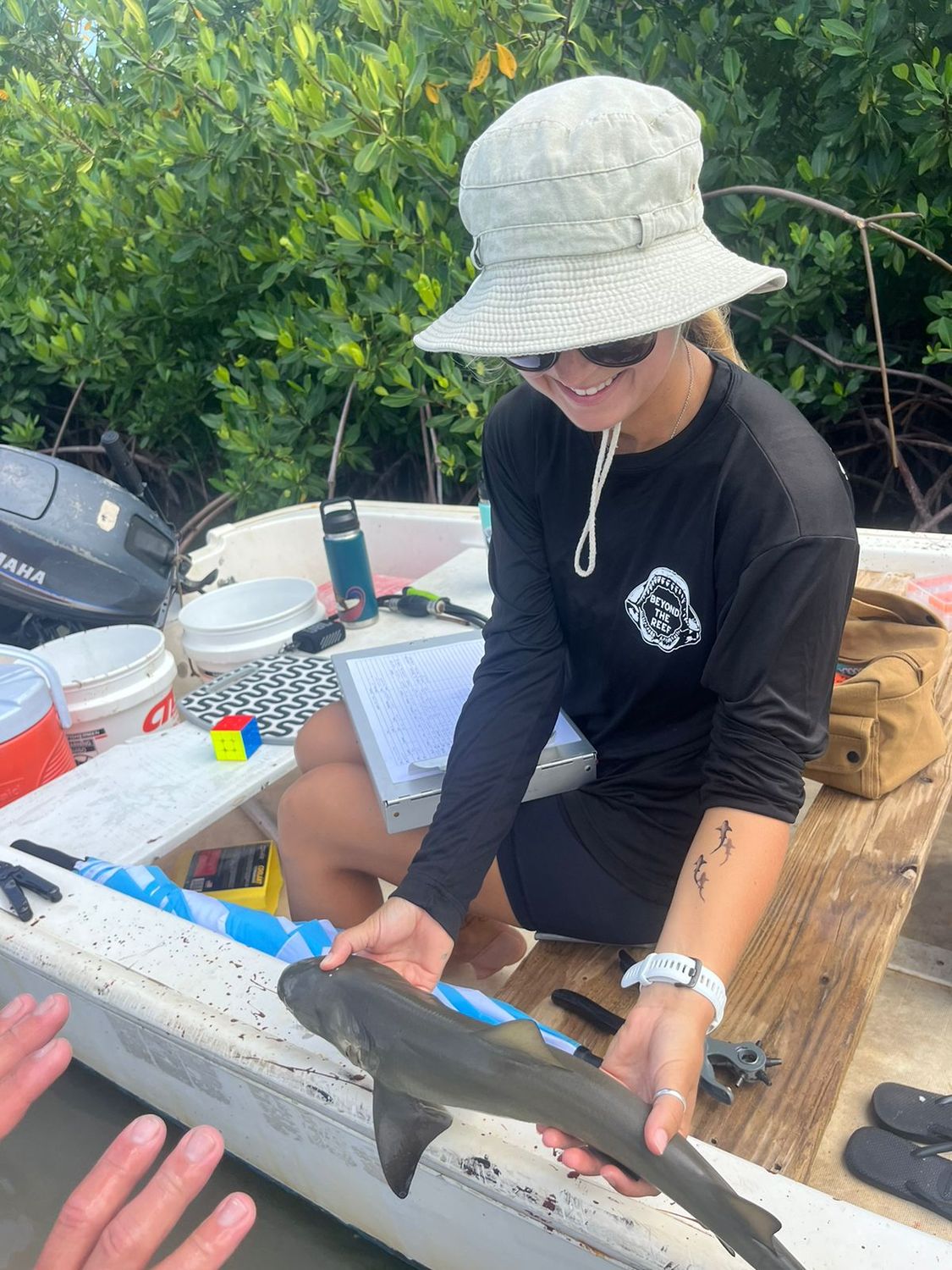 Kendyl Berna with a young shark during a Beyond The Reef tagging session